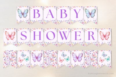 Butterfly themed baby shower banner flags with butterflies, wildflowers and purple serif letters.