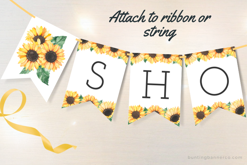 Baby shower bunting flags with watercolor sunflowers and black letters.
