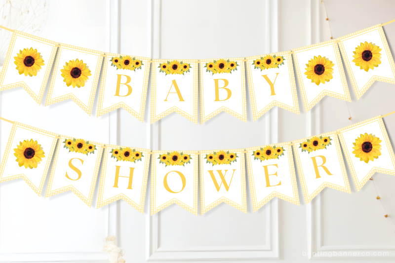 Sunflower baby shower themed banner on wall with watercolor sunflowers and gingham border.