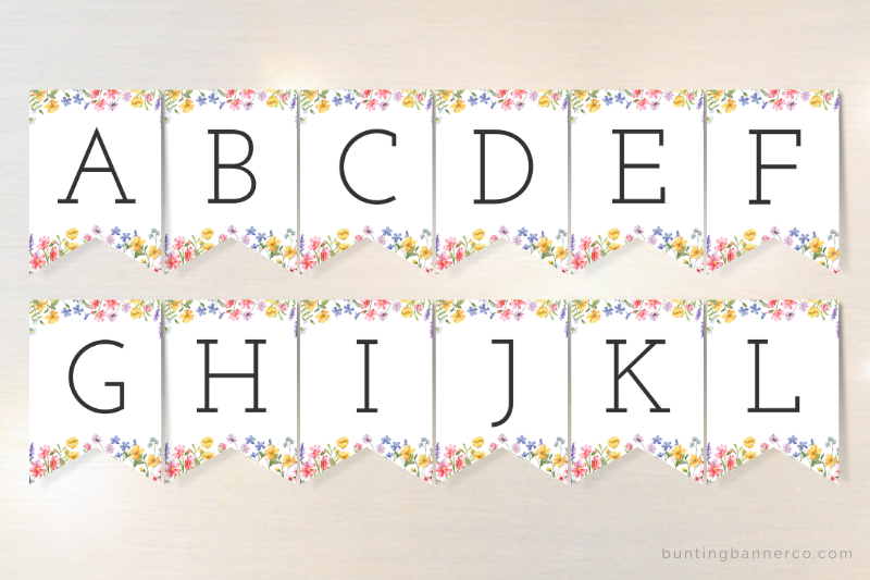 Alphabet bunting flags with black serif font and watercolor wildflowers for baby shower banner customization.