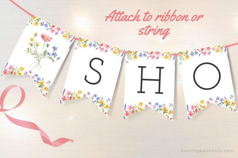 Baby shower bunting flags with watercolor wildflowers and black letters.