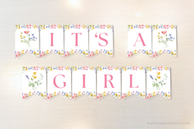 It's A Girl wildflower themed baby shower banner with watercolor wildflowers and foliage.