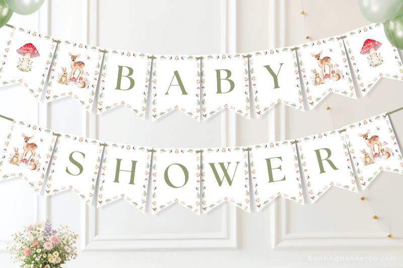 Woodland baby shower banner on a wall with watercolor deer and rabbit and squirrel.