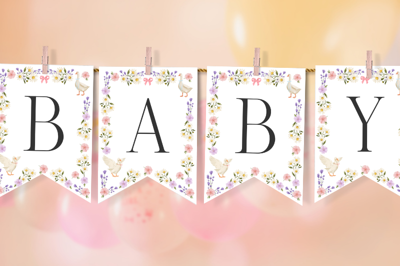 baby shower banner with BABY letter flags with wildflowers and geese attached to string with wooden pegs.