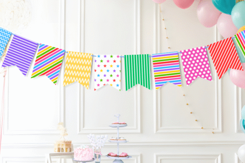 simple colored rainbow birthday bunting decorations hanging on wall